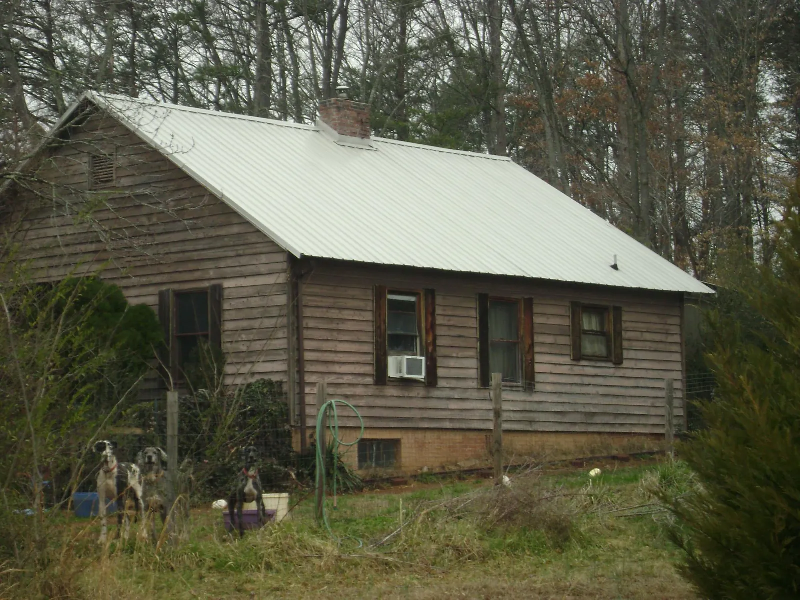 White metal roof on an old wood sided farmhouse, from a Metal Roof Installation job in Palisades Park
